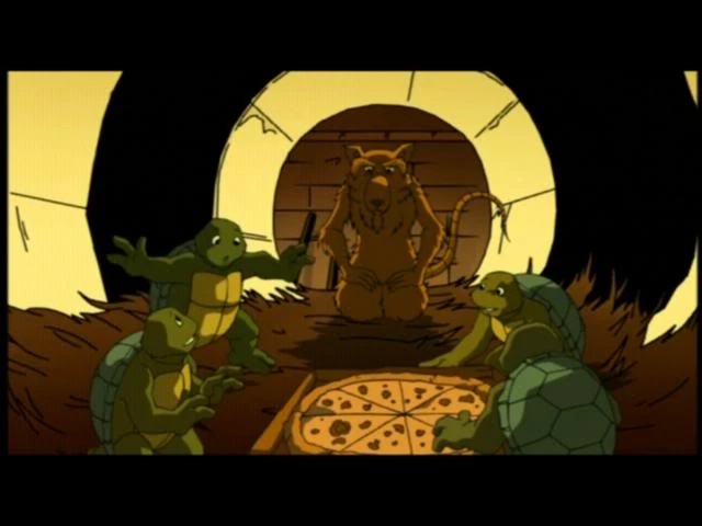 four green anthropomorphic turtles sit around a pizza in a dimly lit lair, looking up at a large brown bear-like creature…