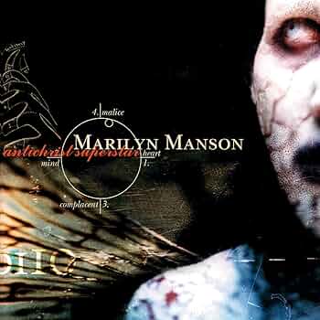 The image is the cover art for Marilyn Manson's album 'Antichrist Superstar,' featuring a close-up of Manson's face with…