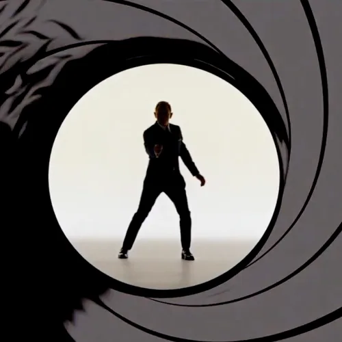 A silhouette of a man in a suit, posed like James Bond, stands centered within the iconic gun barrel opening from a James…