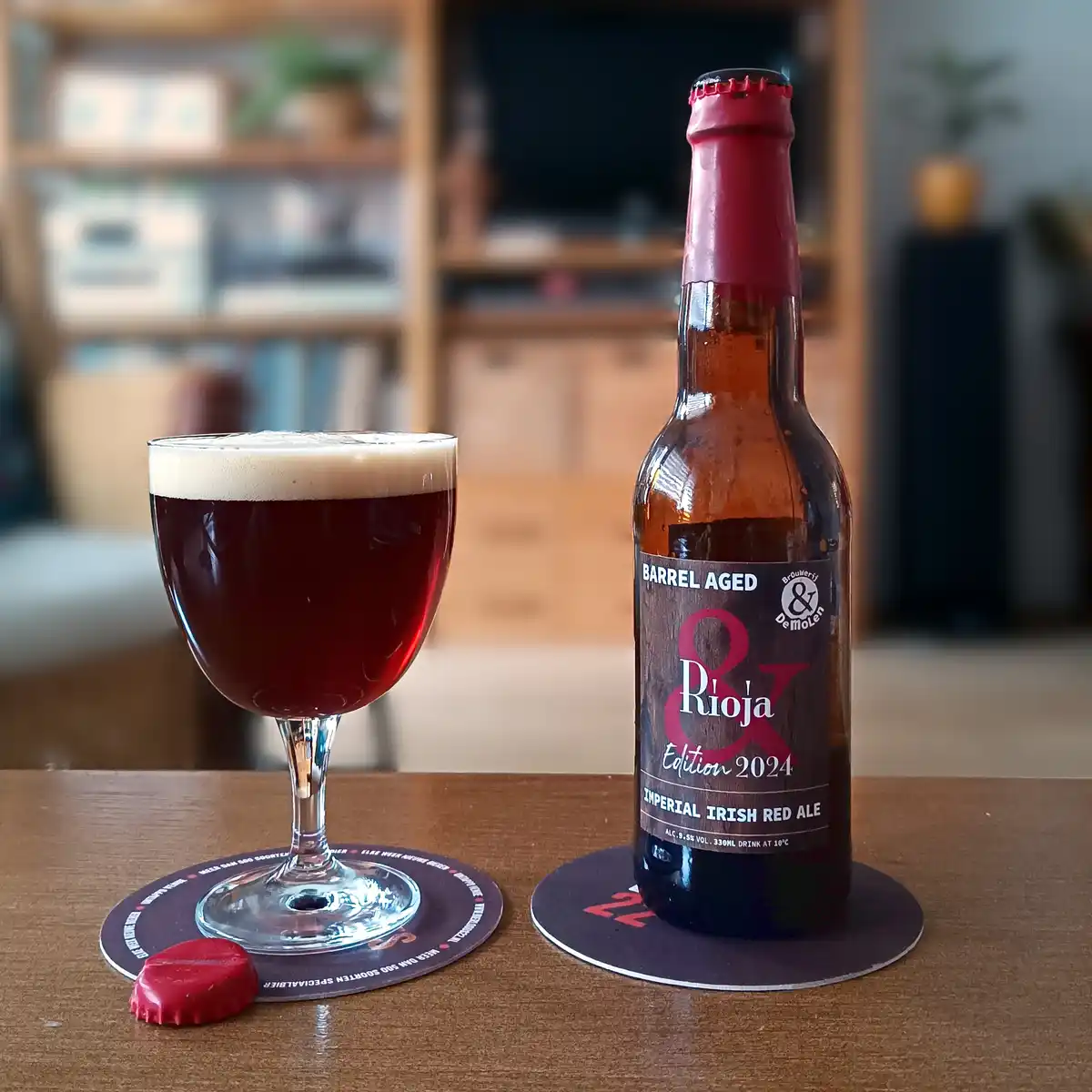 A bottle of 'Barrel Aged & Rioja Edition 2024 Imperial Irish Red Ale' by Brouwerij & Demolen sits next to a filled glass on…