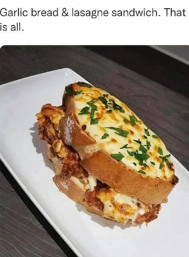 A close-up photo of a sandwich made with two slices of garlic bread, filled with lasagna layers including cheese and sauce…