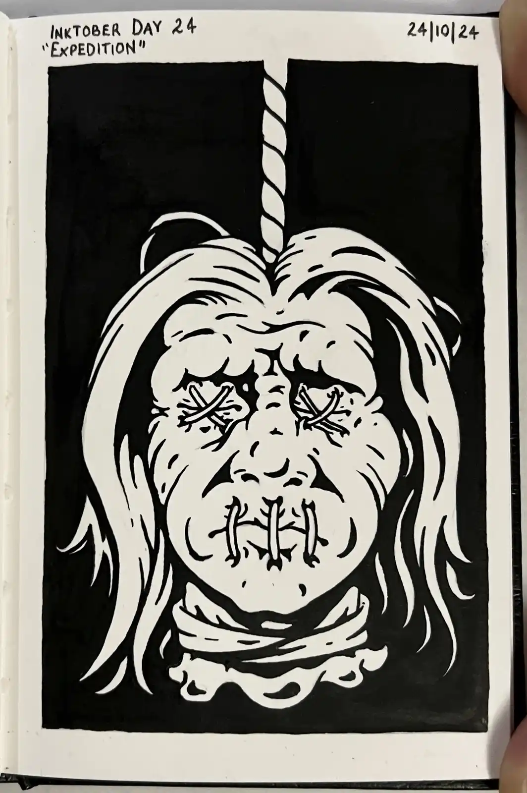 A black-and-white ink drawing shows a grotesque, stitched-up face with a unicorn horn protruding from its forehead, set…
