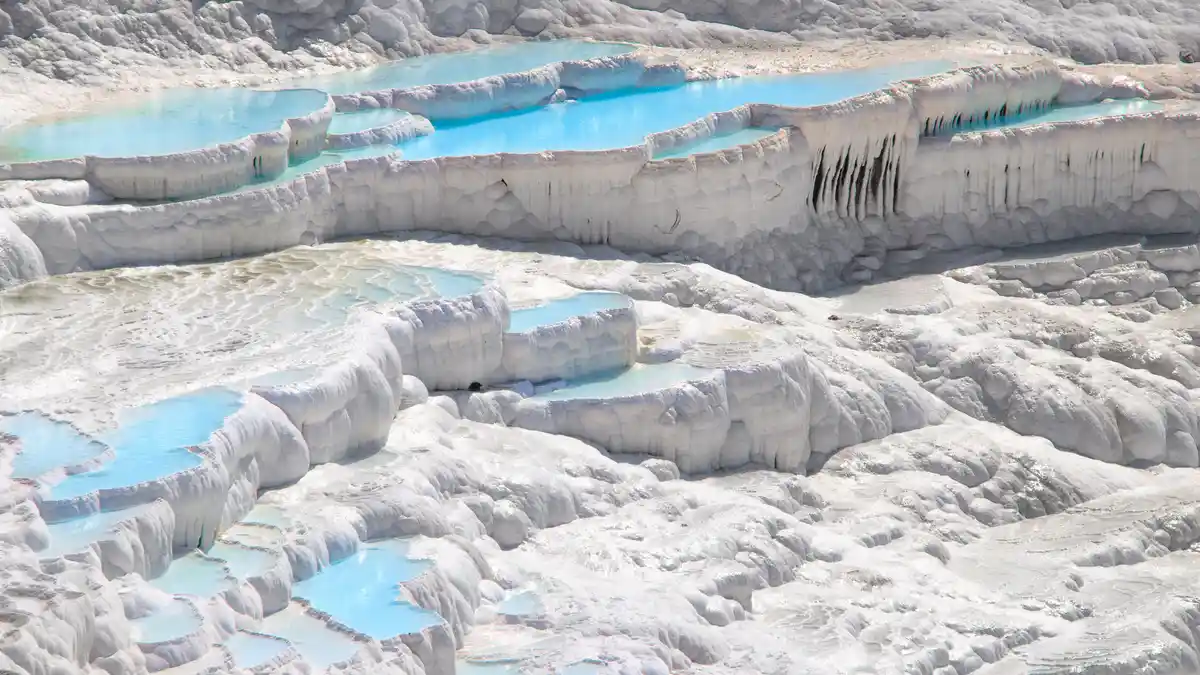 Pamukkale's "cotton castle" nickname is clear when you see its vast, cloud-white travertine terraces in bright daylight. The…