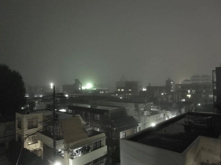 A grainy, foggy night photo of a cityscape with dimly lit buildings and streetlights, overlaid with the text 'i'm not…