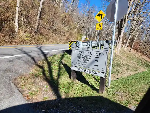 A roadside sign for Pricketts Fort lists attractions like Visitor Center, Restored Fort, Amphitheater, Picnic Area, and Boat…