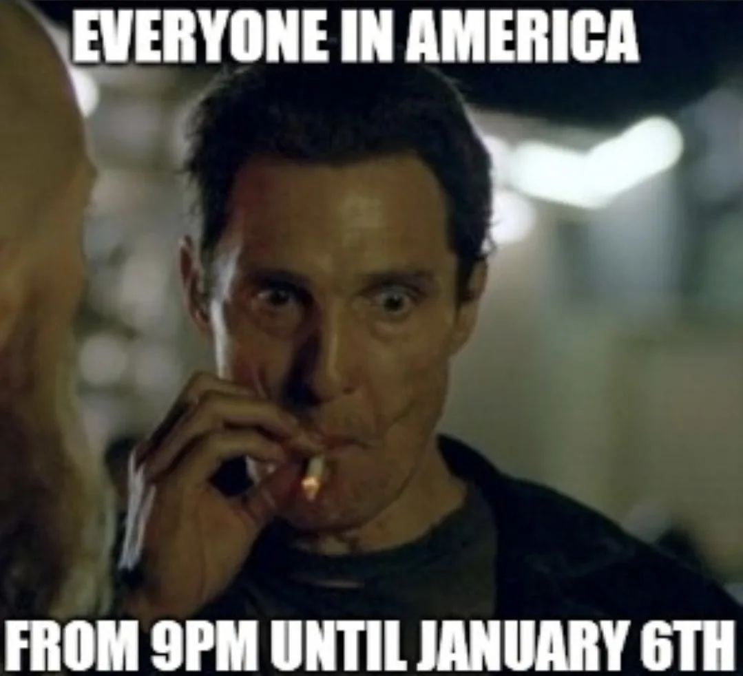 A man with a shocked expression holds a lit cigarette to his lips while looking intensely at someone off-screen. The image…
