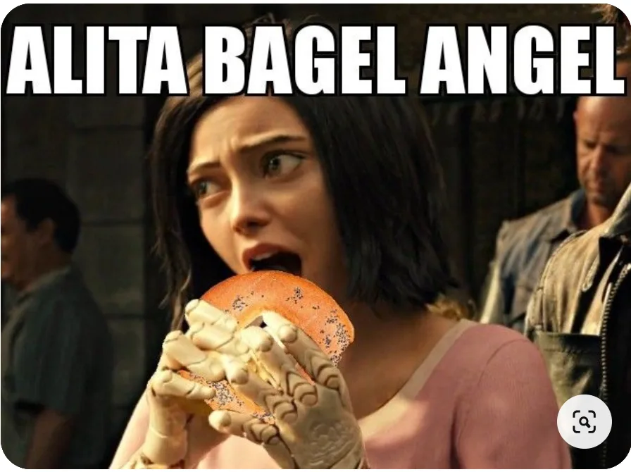A woman with dark hair and robotic hands is shown in a close-up, holding and biting into a bagel with poppy seeds. Her eyes…