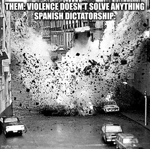 A black and white photo shows a massive explosion in a city street, sending debris and dust high into the air, with cars…
