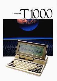 An advertisement image for the Toshiba T1000 laptop, showing the beige portable computer open with a small screen displaying…