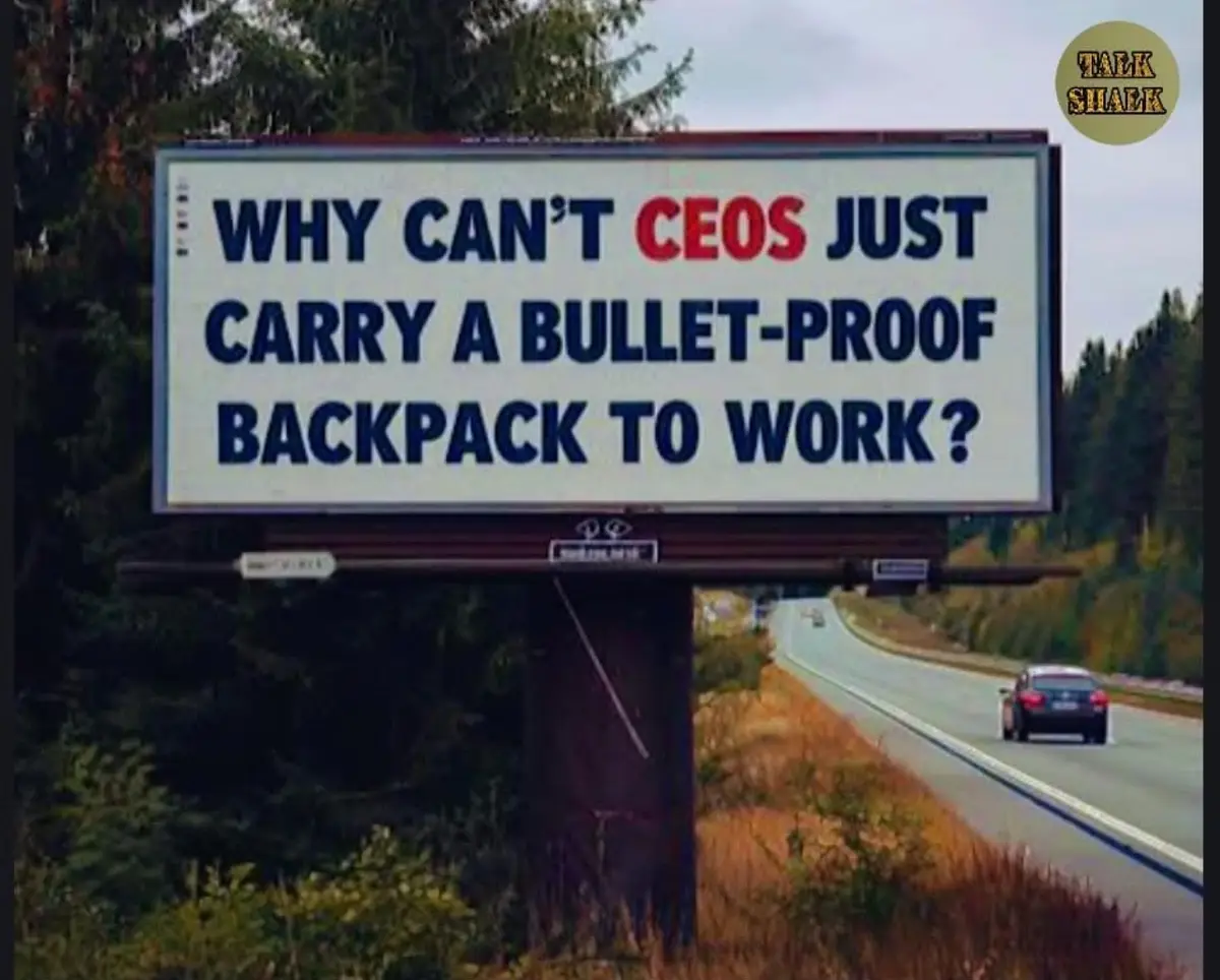 A large roadside billboard displays the text 'WHY CAN'T CEOS JUST CARRY A BULLET-PROOF BACKPACK TO WORK?' in bold blue and…
