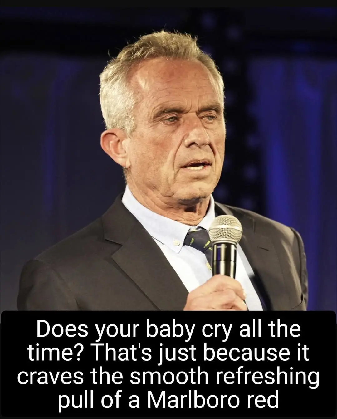 A man in a suit holding a microphone looks concerned while overlaid text reads: 'Does your baby cry all the time? That's…