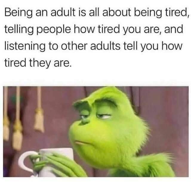 The image shows the green, furry Grinch holding a white mug, looking exhausted with half-closed eyes and a weary expression…