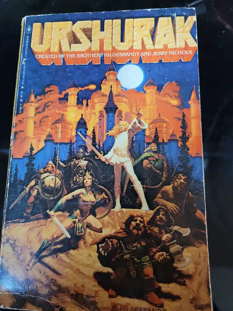 A vintage paperback book cover for 'Urshurak' by the Brothers Hildebrandt and Jerry Nichols, depicting a fantasy scene with…