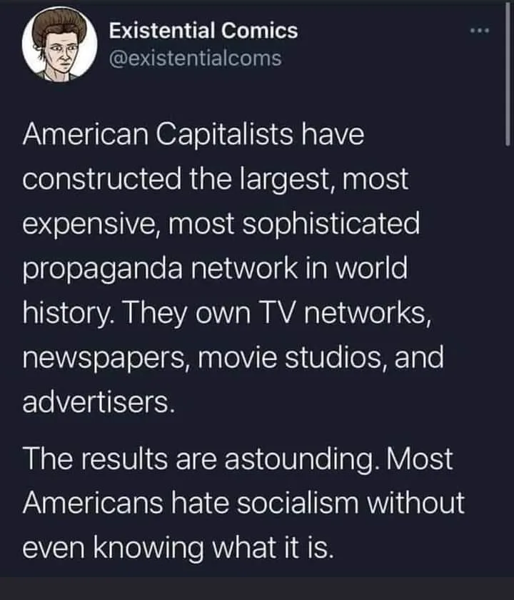 A screenshot of a tweet from 'Existential Comics' with white text on a dark background. The text claims American capitalists…