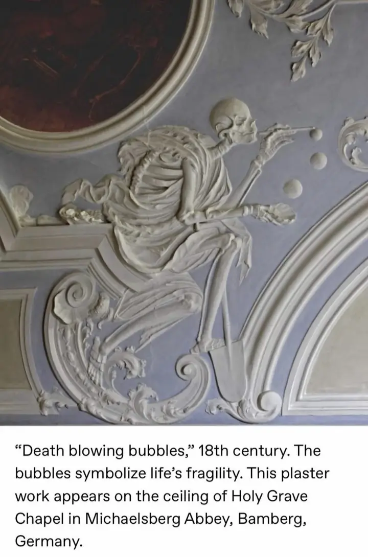 A 18th-century plaster relief on a ceiling depicts a skeletal figure blowing bubbles, symbolizing life's fragility. The text…