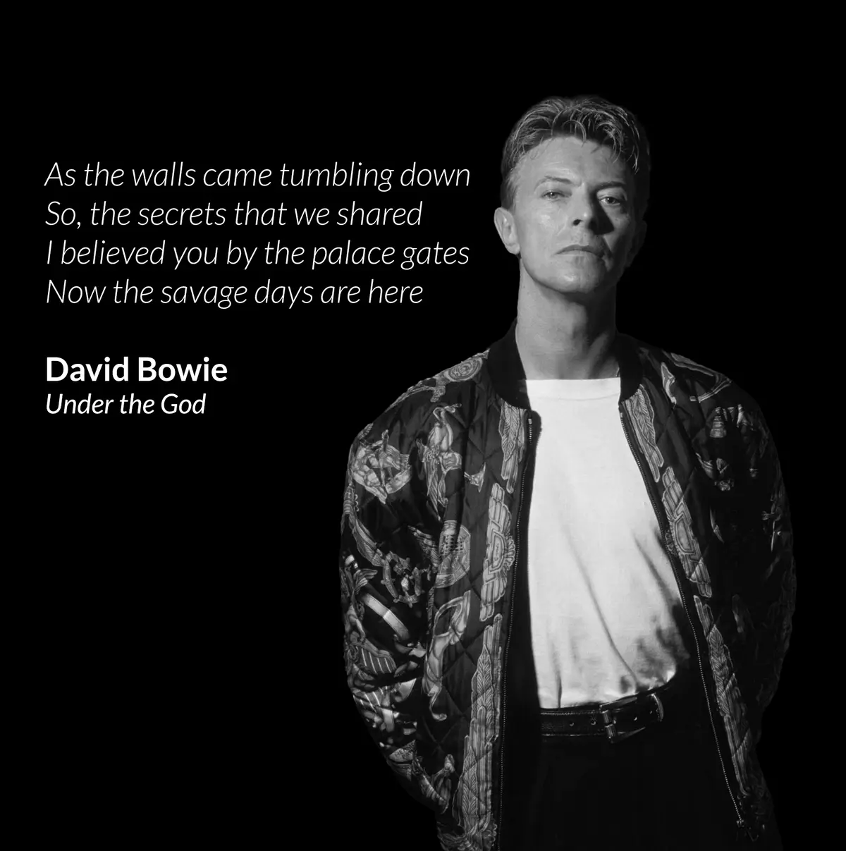 A black and white portrait of David Bowie looking directly at the camera, wearing a patterned bomber jacket over a white…