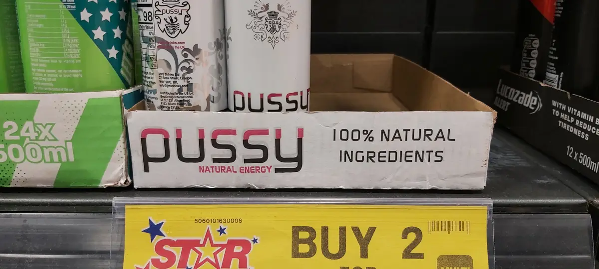 A supermarket shelf displays a box of 'PUSSY NATURAL ENERGY' drinks, which claims '100% NATURAL INGREDIENTS' on its…