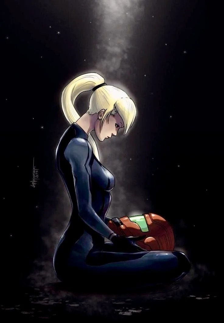 A blonde woman in a dark blue bodysuit kneels in a starry void, holding a glowing orange helmet. She looks down with a…