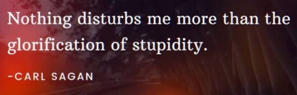 The image displays a quote in white serif font over a dark, blurry background with reddish-orange lighting and indistinct…