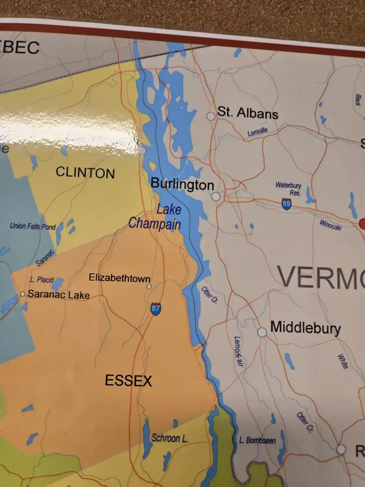 A close-up of a printed map showing the northeastern United States, highlighting Lake Champlain between Vermont and New…