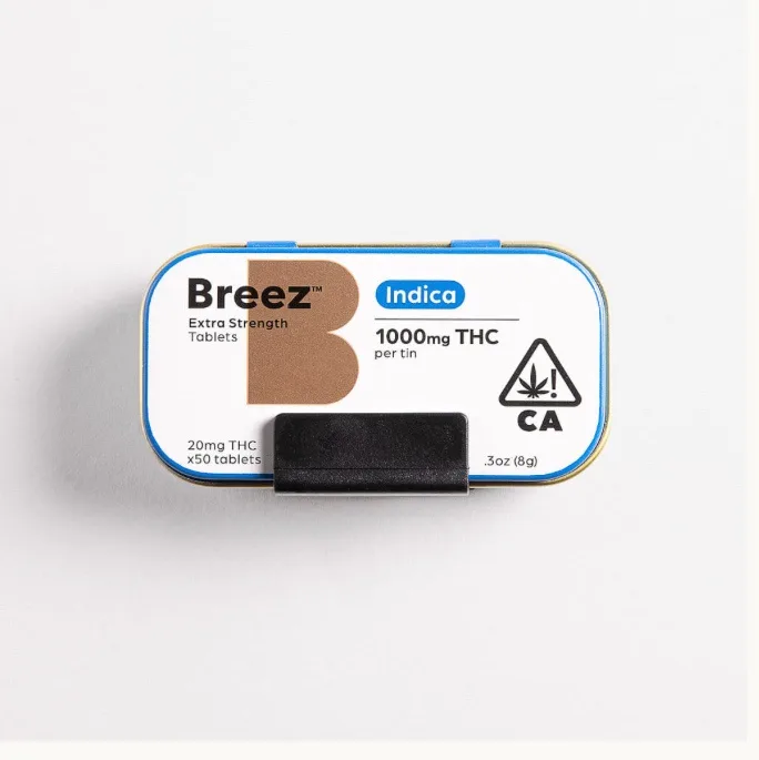 A product tin labeled 'Breez Extra Strength Tablets Indica' with '1000mg THC per tin' and '20mg THC x50 tablets' visible…