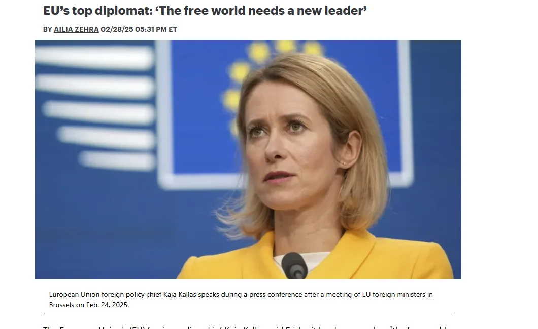 A woman with blonde hair wearing a yellow blazer stands at a podium in front of a blue background with a European Union…