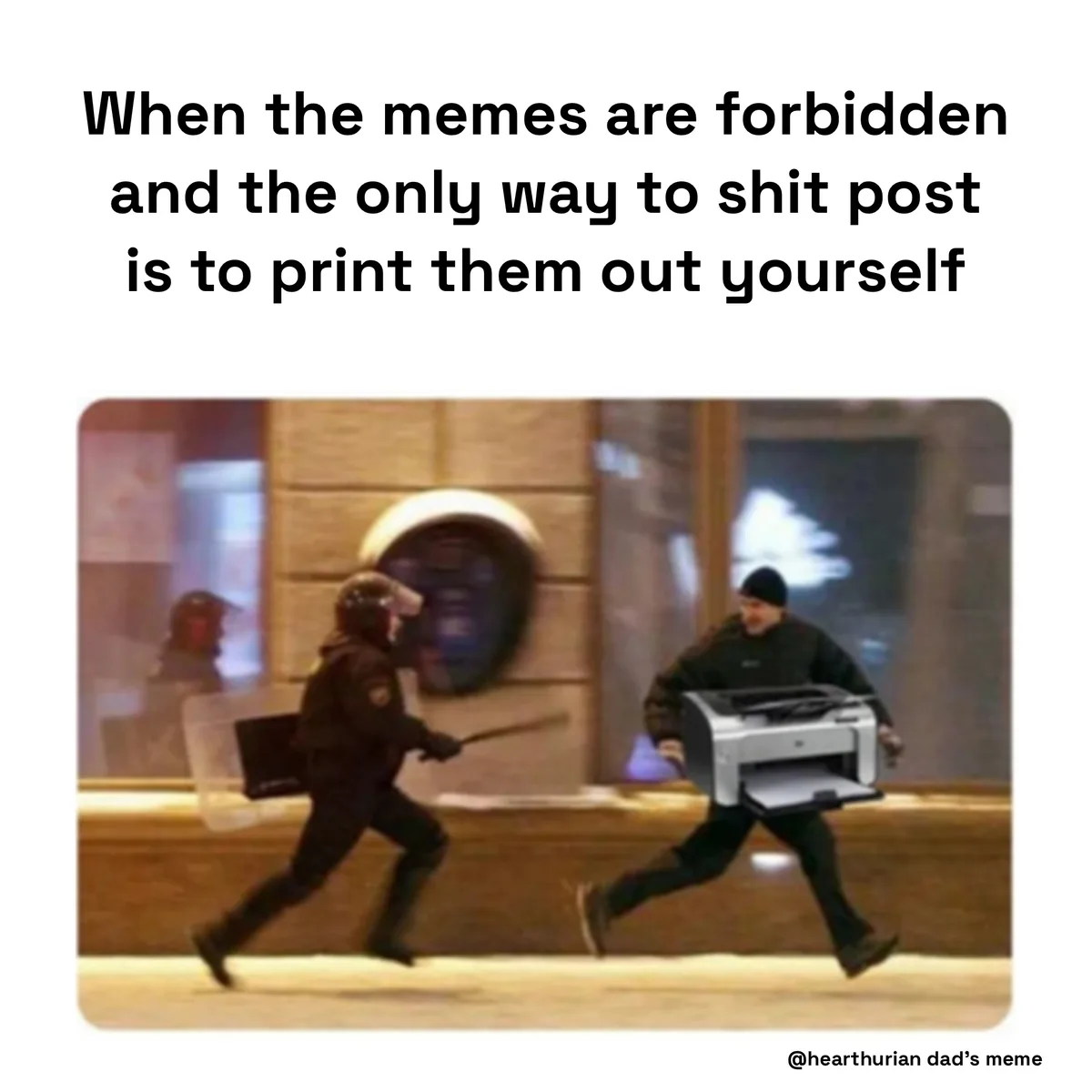 A blurry photo shows a person in dark clothing running while carrying a printer, pursued by a police officer in tactical…