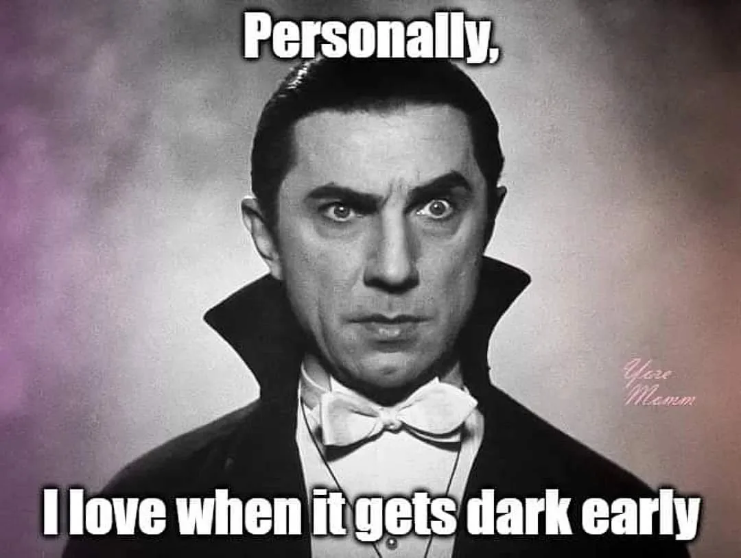 A black-and-white photo of actor Bela Lugosi as Count Dracula, wearing a formal black cape and white bow tie, with a…