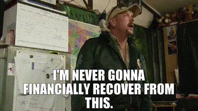 The image shows a man in a green jacket and cap standing in a cluttered room with maps and boxes on the walls. He is…