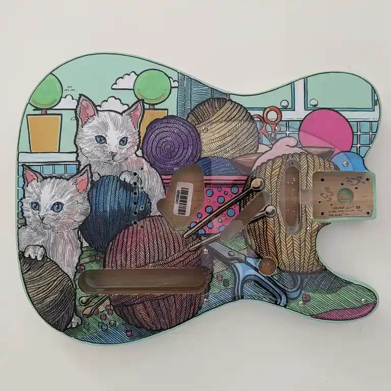 A hand-painted guitar pickguard shaped like a guitar body, featuring two illustrated white cats with blue eyes, surrounded…