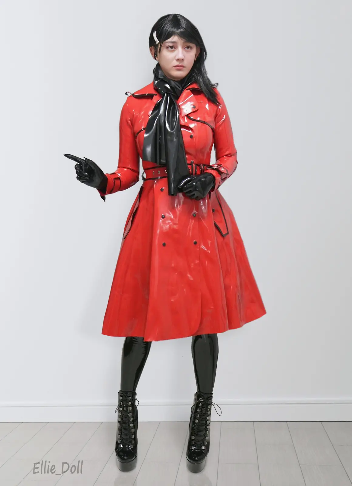 A person in a full-body cosplay of a character wearing a shiny red trench coat, black gloves, a black scarf, black…