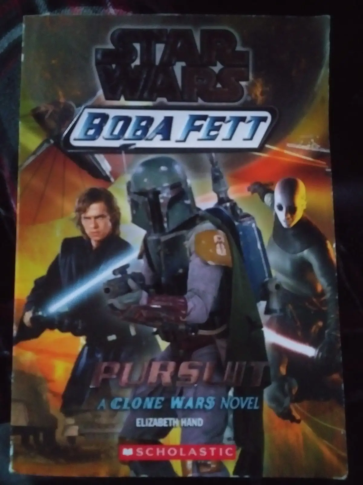 The image shows the cover of a Star Wars novel titled 'Boba Fett: Pursuit: A Clone Wars Novel' by Elizabeth Hand, published…