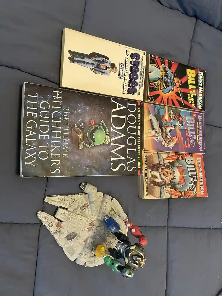 Five vintage science fiction paperbacks, including 'The Ultimate Hitchhiker's Guide to the Galaxy' by Douglas Adams and…