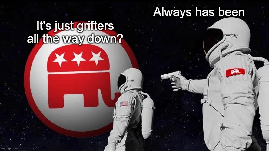 Two astronauts in space, one pointing a gun at the other. Behind the astronaut on the left is a large red and white…