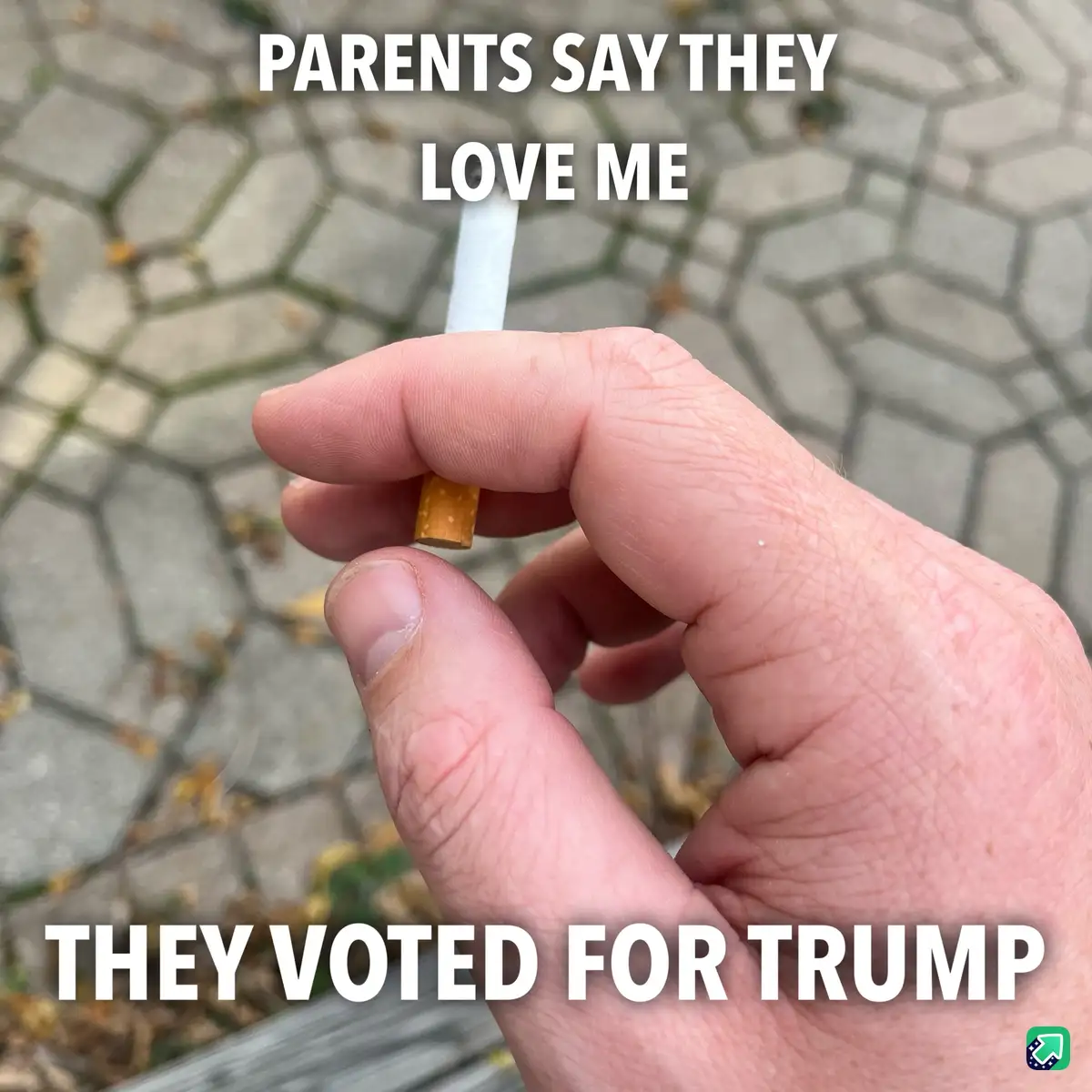 A close-up photo shows a hand holding a lit cigarette against a blurred background of hexagonal paving stones. White bold…