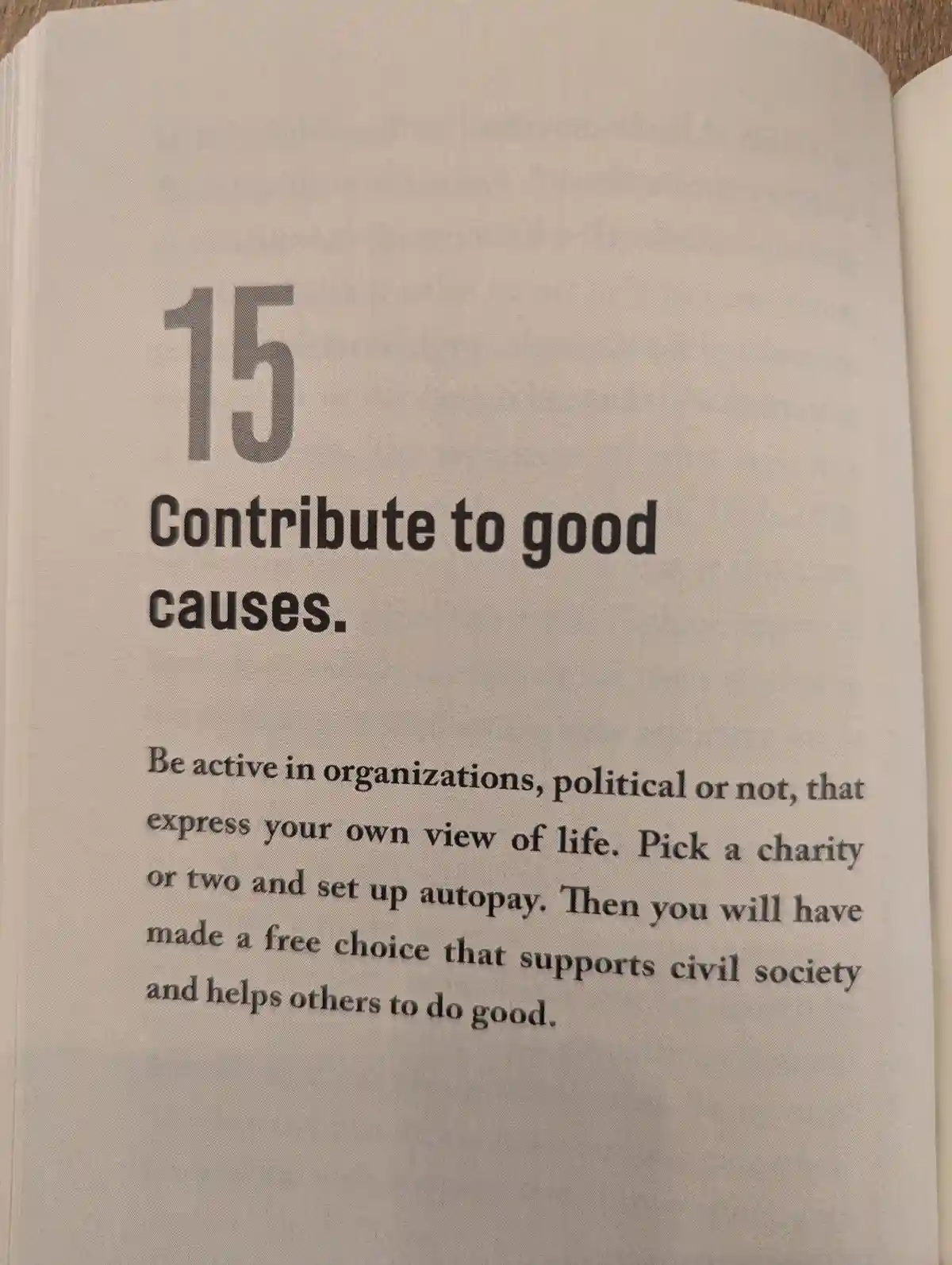 A close-up photo of a book page showing item 15, which reads 'Contribute to good causes.' The text advises being active in…
