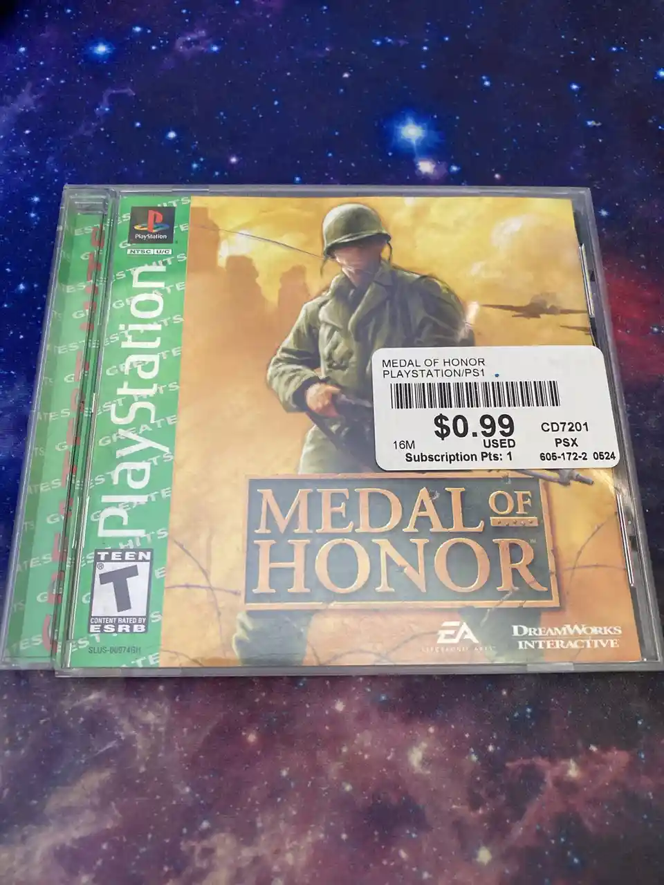 A PlayStation 1 game case for 'Medal of Honor' is shown with a price sticker indicating it costs $0.99 used. The cover art…