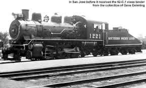 A black and white photograph of a steam locomotive, number 1221, with "SOUTHERN PACIFIC" written on its side, standing on…