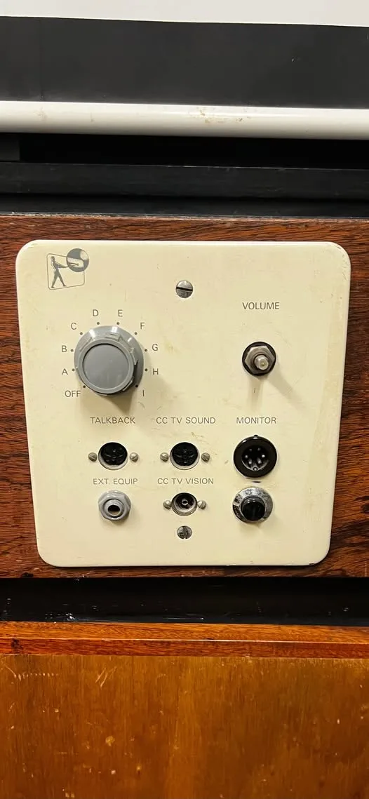 A close-up of a vintage beige control panel with a large rotary knob labeled with positions A through I and 'OFF'…