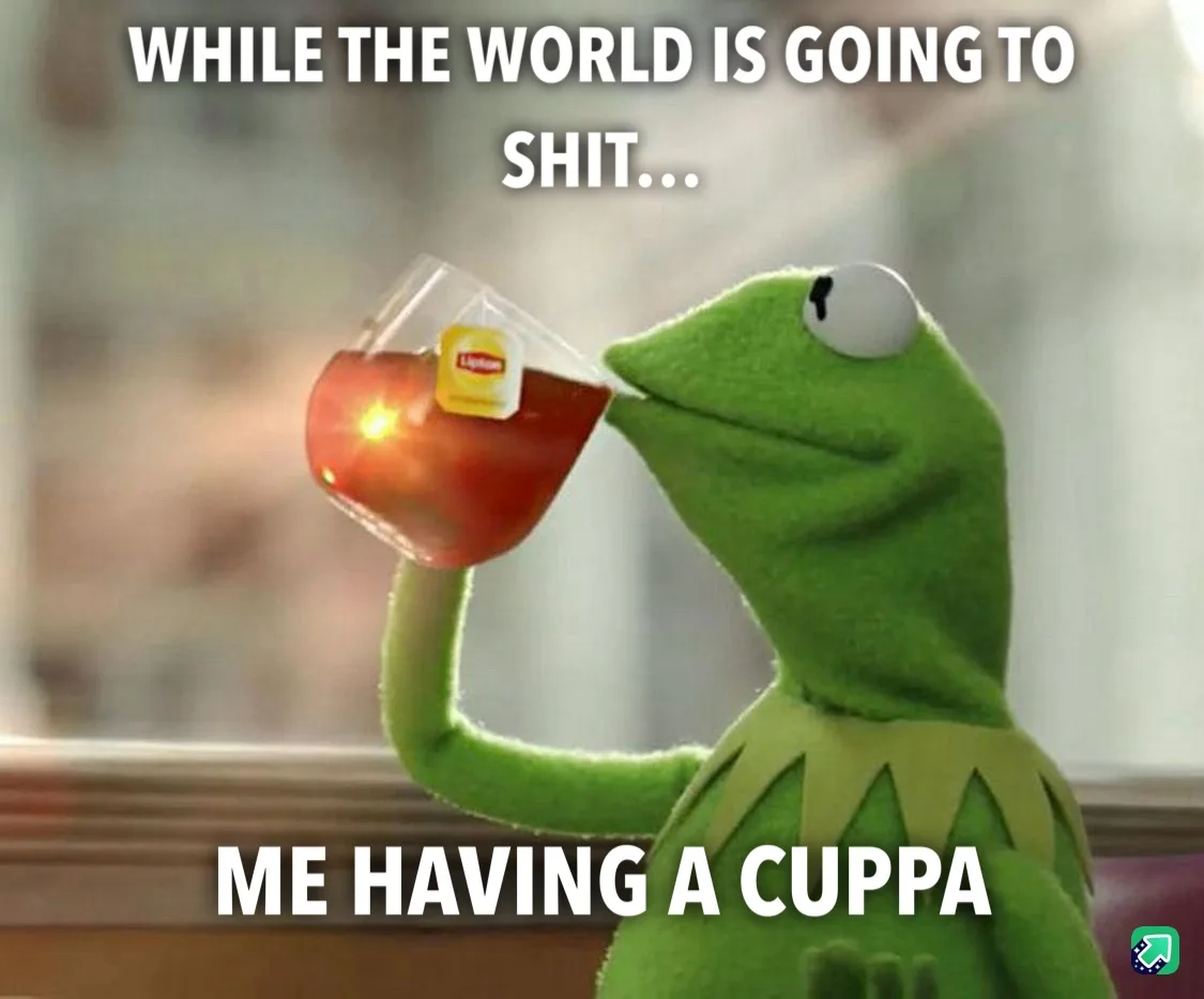 A green frog puppet, Kermit the Frog, is shown sipping tea from a clear glass mug with a Lipton tea bag tag visible. The…