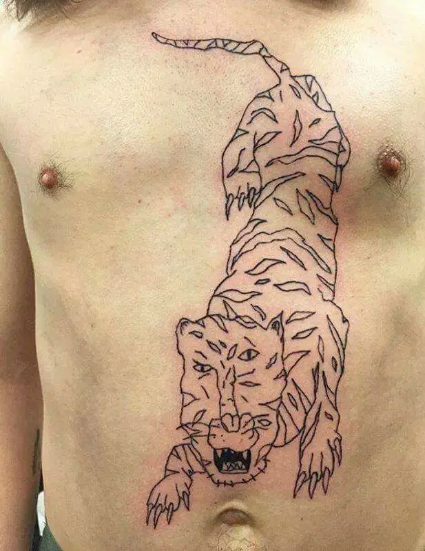 A shirtless person's torso displays a black-and-white tattoo of a tiger that appears to be climbing upward from the lower…
