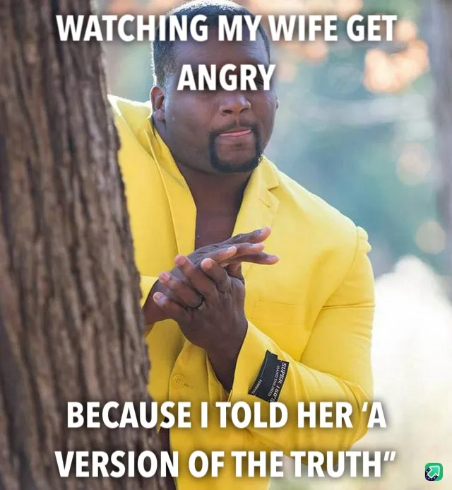 A man in a bright yellow suit peeks from behind a tree trunk, hands clasped together with a smug or amused expression. White…