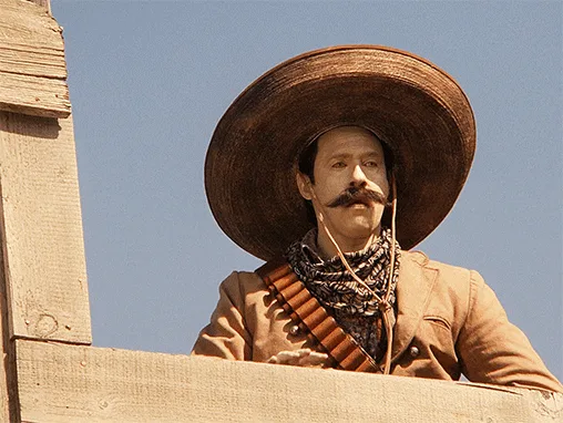 The image shows six identical panels of a man in a large sombrero and brown jacket, leaning over a wooden railing against a…