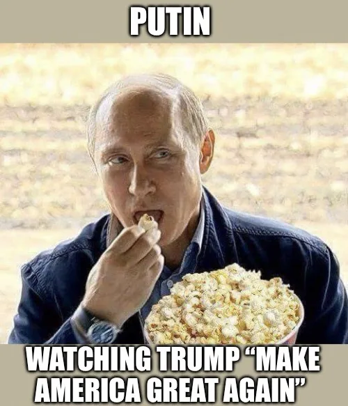 A man with a receding hairline, wearing a dark blue jacket over a collared shirt, is shown eating popcorn from a large bowl…