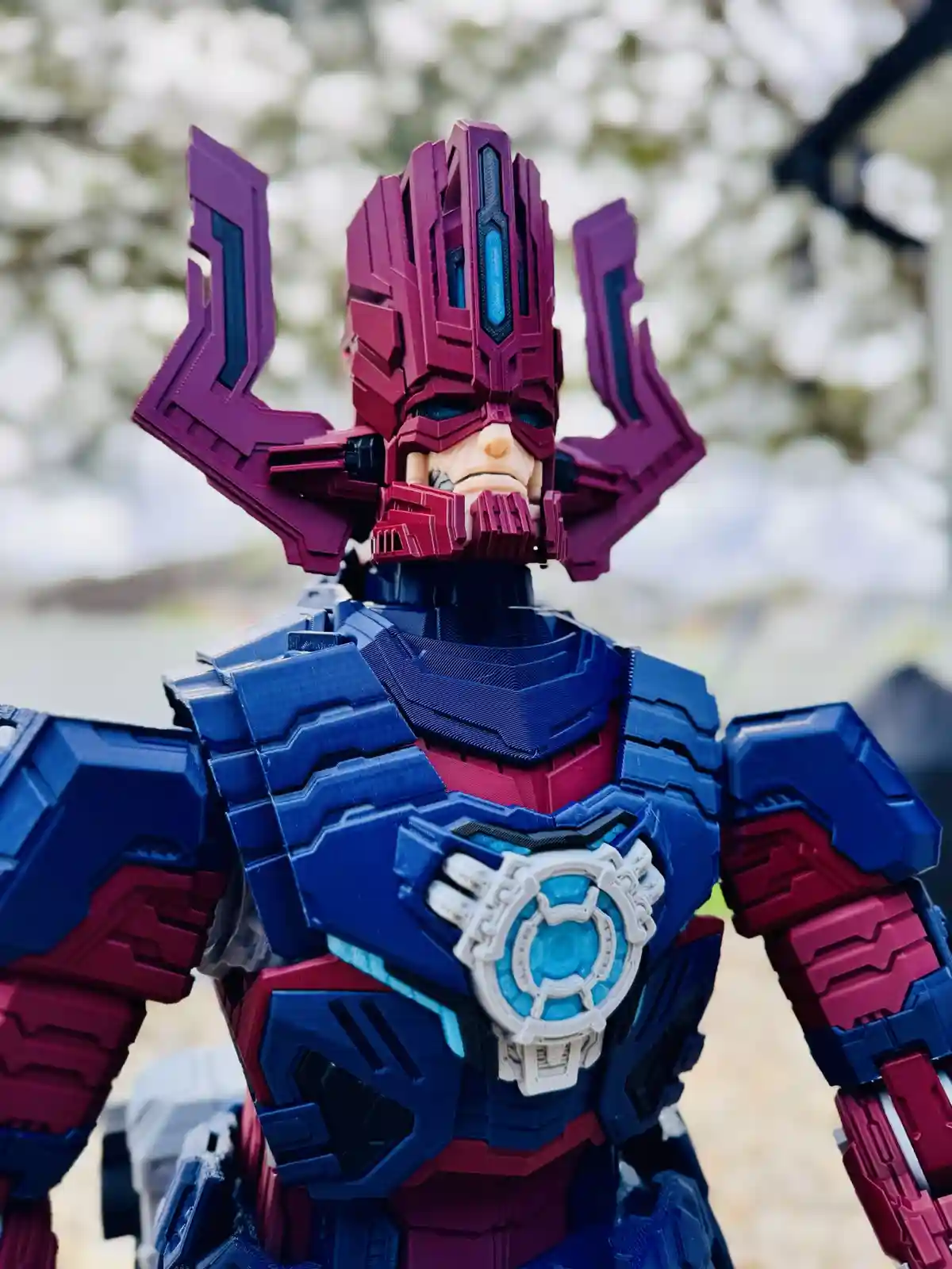 A close-up photo of a detailed action figure resembling a robotic or armored superhero, primarily blue and purple with…