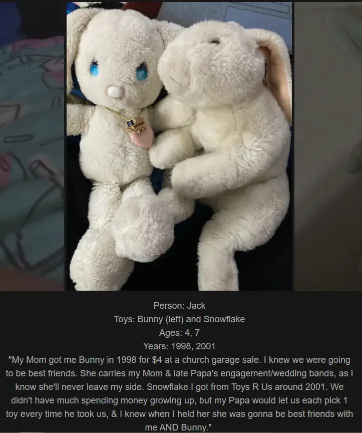 Two white stuffed bunnies are shown cuddling together. The bunny on the left has blue eyes and wears a gold necklace with a…