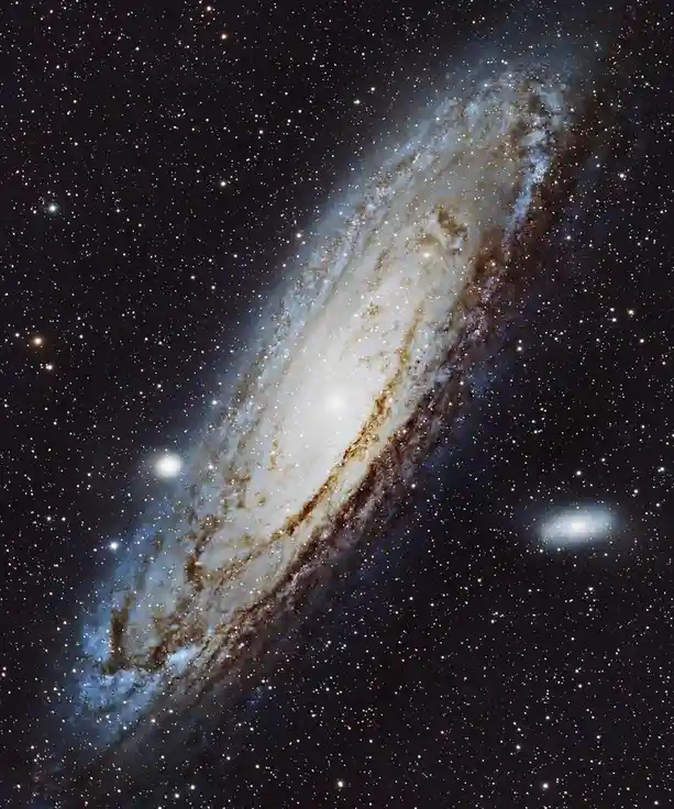 A stunning space photograph shows a large spiral galaxy with bright blue and white arms and a dense central core, set…