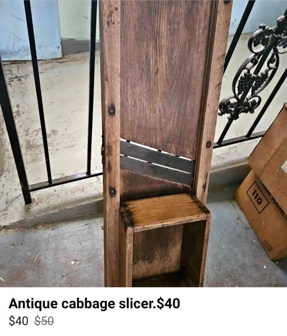 A wooden object resembling a guillotine with a small cutting blade and a base for holding produce is photographed in a…