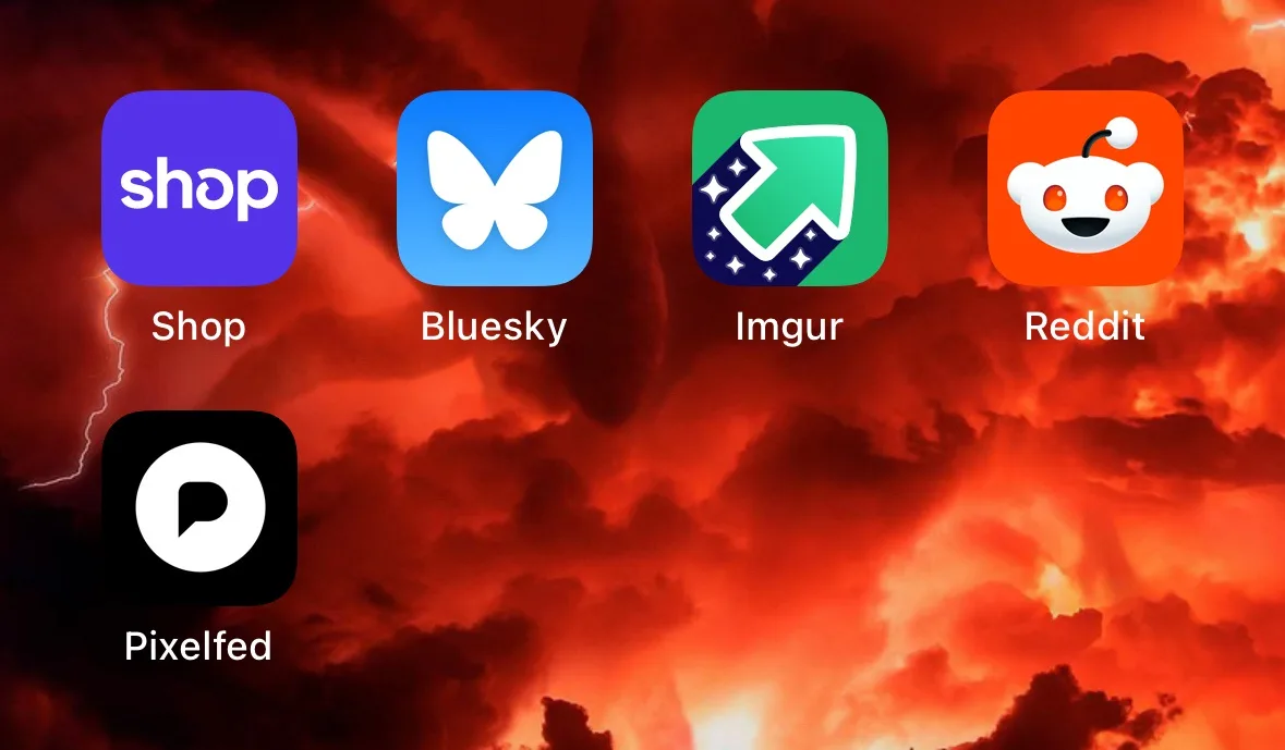 Five app icons — Shop, Bluesky, Imgur, Reddit, and Pixelfed — are displayed against a fiery, apocalyptic sky background…