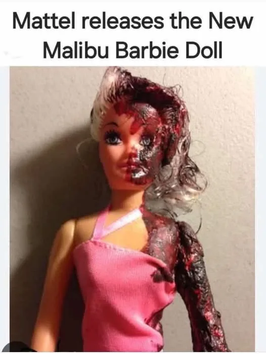 A Barbie doll is shown with severe, gruesome damage: half her face is melted and charred, her hair is singed and matted, and…